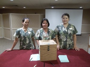 Housekeepers at the Hyatt Regency Waikiki place their contract ratification votes