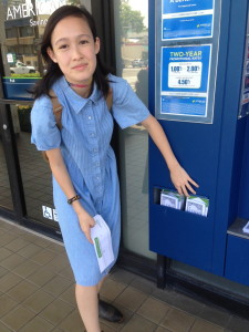 A local student who is concerned about bank teller pay leaves leaflets at a local American Savings Bank branch.